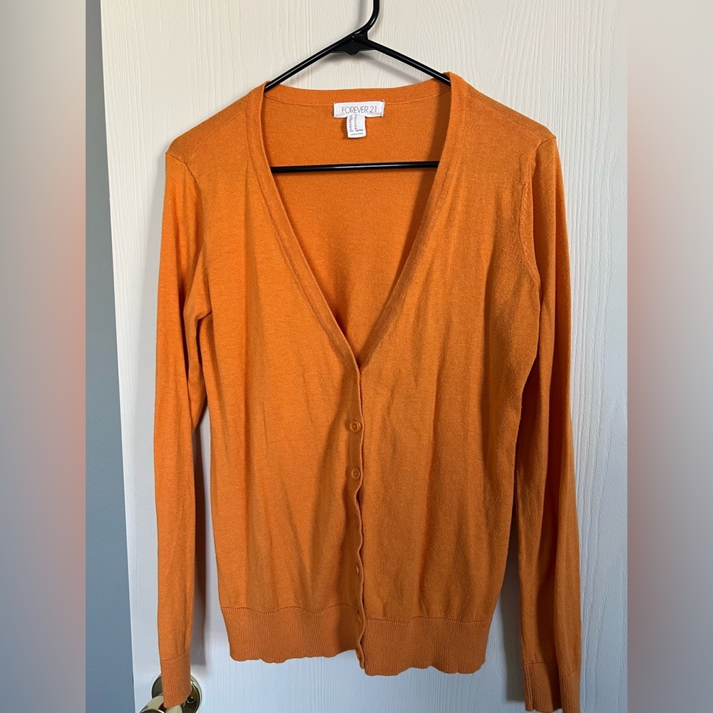 Orange cardigan.